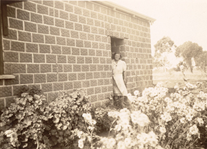 Grandmother at back door of country home, curca 1935